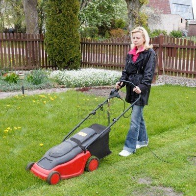 16523211-woman-mowing-grass-with-an-electric-lawn-mower