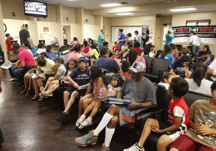 Children and their parents wait in line for medical services during a back to school health fair for existing patients of the Oklahoma City Indian Clinic in Oklahoma City, OK, Friday, July 19, 2013. Photo by Paul Hellstern, The Oklahoman